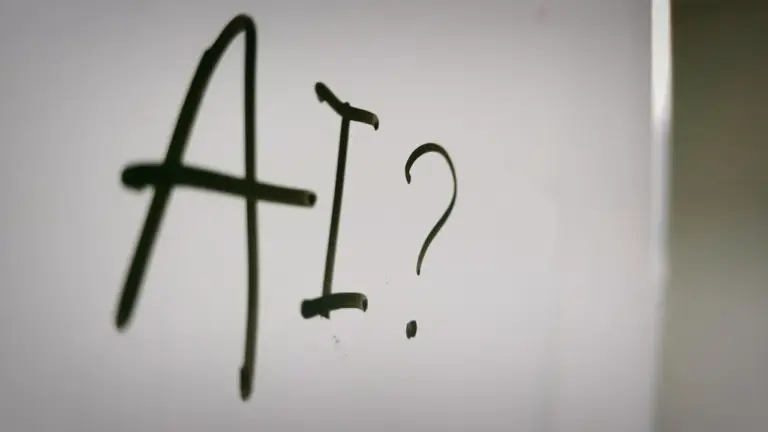 AI written on glass with question mark