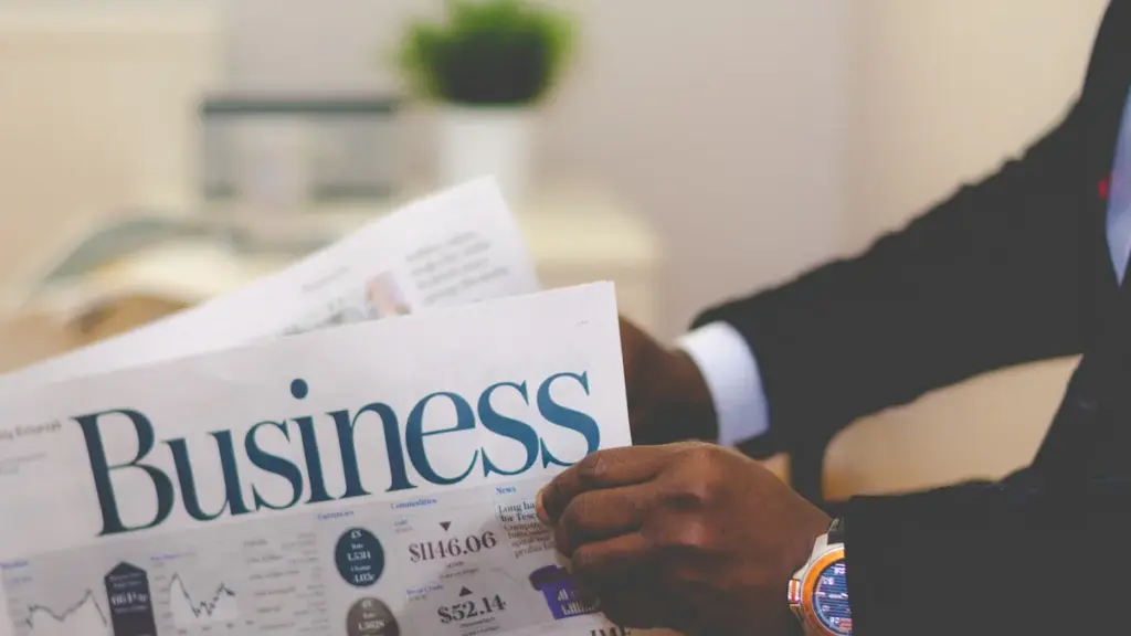 Businessperson reading business section of newspaper