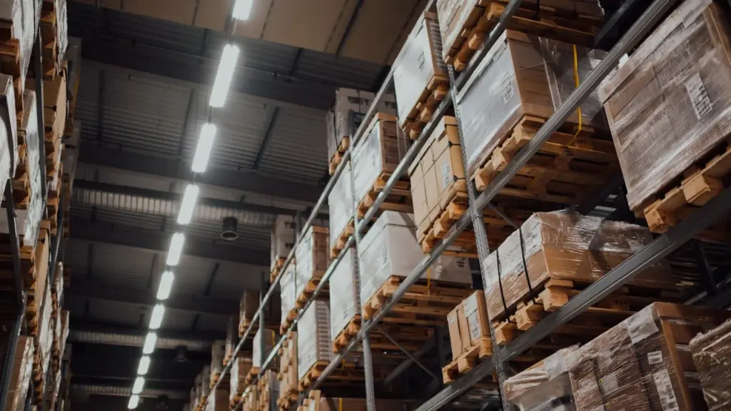 Warehouse shelves stacked with pallets and boxes