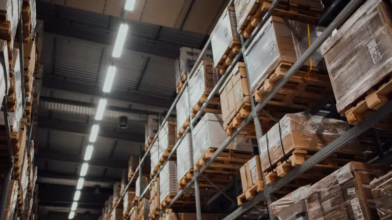 Warehouse shelves stacked with pallets and boxes
