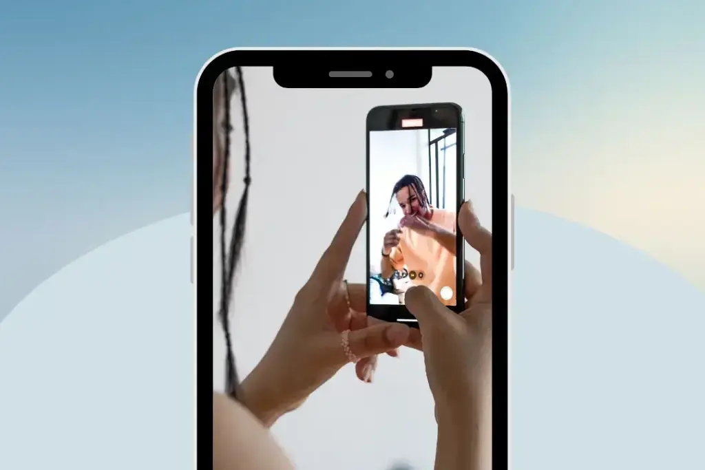 Person recording video on smartphone screen.