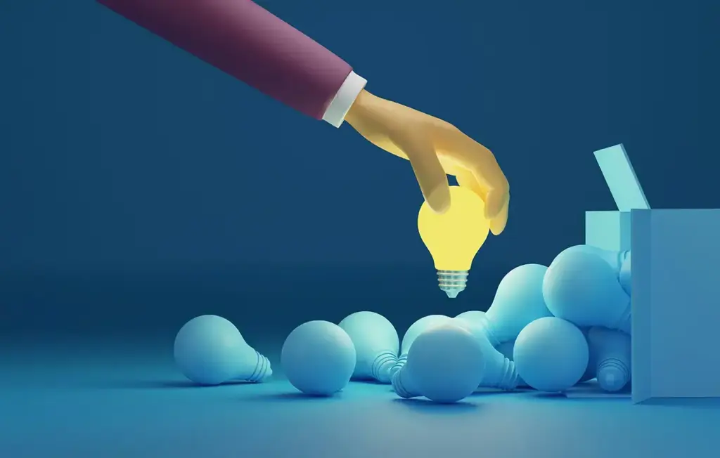 Hand picking glowing light bulb from box.